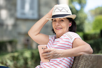 senior woman relaxing on park bench