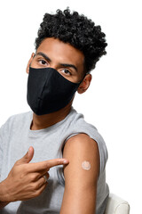 teenage boy shows vaccine mark shortly after being vaccinated during the covid-19 coronavirus...