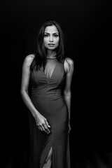 Studio images of beautiful Asian Indian woman wearing red dress on black background. 