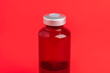 Macro Image Of Amber Vaccine Vial Set On Red Background