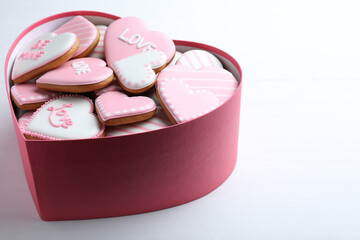 Delicious heart shaped cookies in box on white table. Valentine's Day