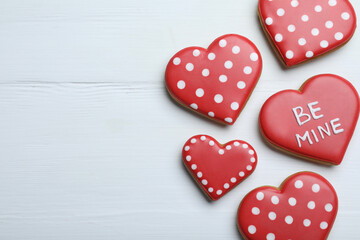 Delicious heart shaped cookies on white wooden table, flat lay with space for text. Valentine's Day