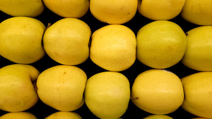yellow apples on a market stall