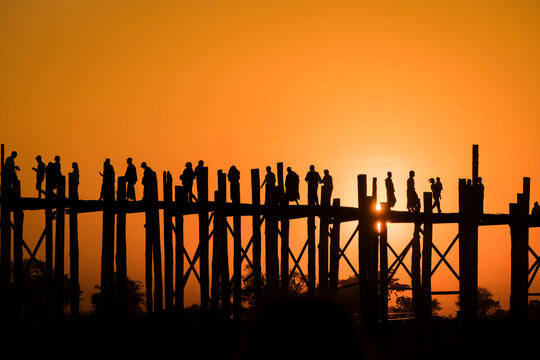 Silhouette people walking on U Bein bridge against clear sky during sunset, Amarapura, Mandalay, Myanmar