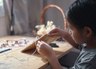A girl making a handmade book by herself