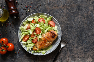 Baked chicken breast with honey and salad with cabbage and tomatoes. Healthy food, keto diet, paleo diet. Top view with copy space.