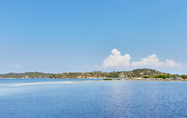 Look at Diaporos Island over Livari beach, Sithnonia, Halkidiki, Greece; shallow water sea shelf