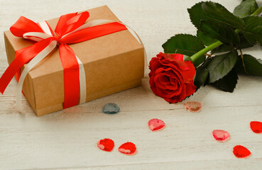 Background with red hearts, gifts and a red rose. Valentine's Day.