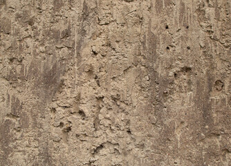 Old retro scrutched yellow brown sandstone wall texture background.