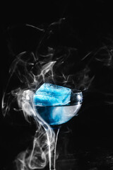 cocktail with smoke and blue ice