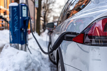 Electric car getting charged in Montreal after snowstorm