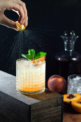 whiskey cocktail with peaches and mint