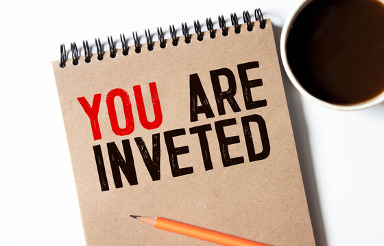businessman holding a card with text YOU ARE INVETED