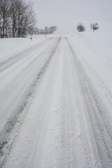 Snow-covered road in winter in the countryside