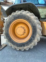 yellow excavator wheel on a construction site