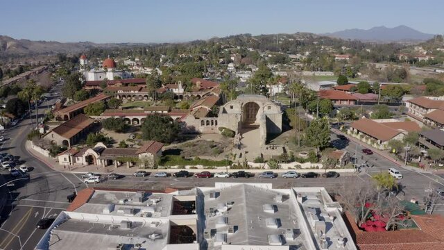 Daytime aerial view of the Spanish Colonial era mission and surrounding city of downtown San Juan Capistrano, California, USA. 