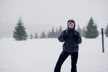 Fototapeta na wymiar Hiker Walking in Mountains in Winter
