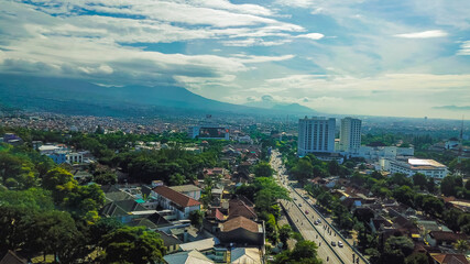 Wide aerial View of Dago Street, one of the main street in Bandung, with a beautiful mountain view in the background.