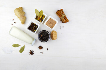 Ingredients for making Indian masala tea (masala chai). Dried black tea, milk, anise star seeds,...