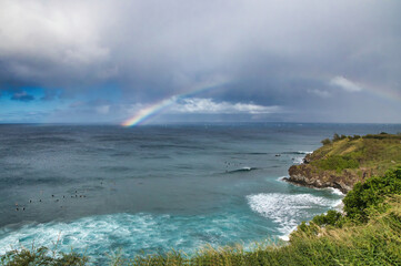 Streaking, brilliant rainbow over Honolua Bay on Maui.
