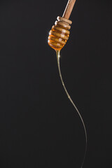 honey dripping from a stick