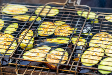 barbeque cooking aubergine or eggplant on fire. grilled dish outdoors