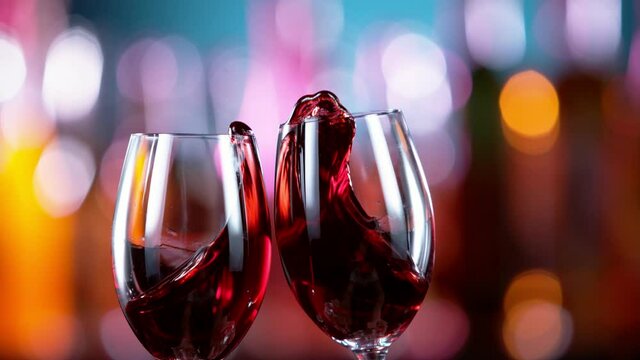 Super slow motion of red wine glasses in cheers gesture. Filmed on high speed cinema camera, 1000 fps.