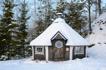 Ruskeala, Russia - January 15, 2021: Wooden house in Ruskeala mountain park
