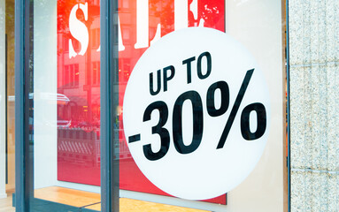 A big discount label in showcase of a store during sales season.