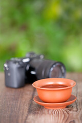 A bowl of tea and a camera