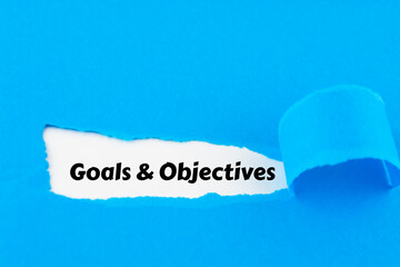 Goals and Objectives words written under torn paper.