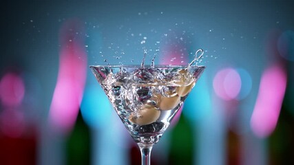 Super slow motion of falling olives into cocktail drink. Filmed on high speed cinema camera, 1000 fps. - Powered by Adobe