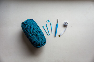 Flat lay of knitting string and hooks