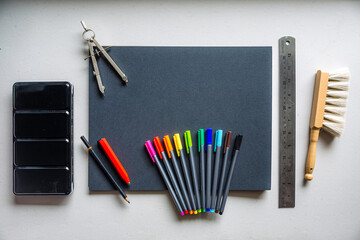 Notebook with colorful art supplies