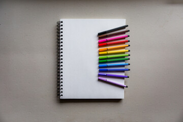 Notebook with colorful art supplies