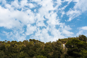 Clouds in the blue sky at Cala Macarelleta, Menorca, Balearic Islands, Spain