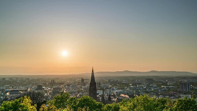 Time-lapse, panorama of Freiburg im Breisgau in Germany at sunset, Freiburg Munster medieval cathedral at dusk