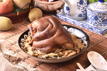 Stewed pork trotters with bamboo shoots in brown sauce on the plate 