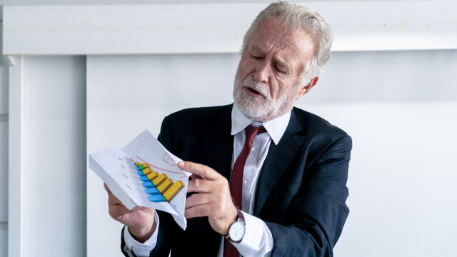 Portrait Happy Senior Businessman Relax And Folding Paper Plane From Document File Graph In Office.