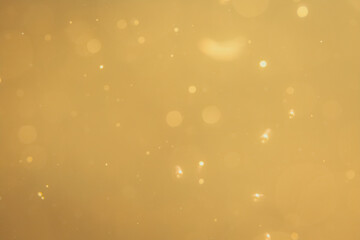 Dark Abstract Gold bokeh sparkle on black background