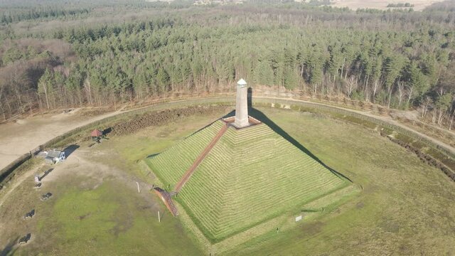 Drone pulling away from Austerlitz pyramid on a sunny day. The Piramide van Austerlitz is a monument in the Netherlands, built in 1804 as a tribute to Napoleon Bonaparte.