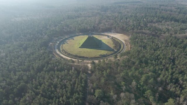 Flying towards Austerlitz pyramid in beautiful forest in the Netherlands. The Piramide van Austerlitz is a monument in the Netherlands, built in 1804 as a tribute to Napoleon Bonaparte.