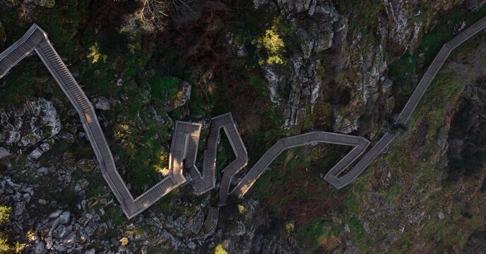 Aerial panorama of wooden walkway zigzag stairs staircase nature hiking trail path Passadicos do Paiva Arouca Portugal