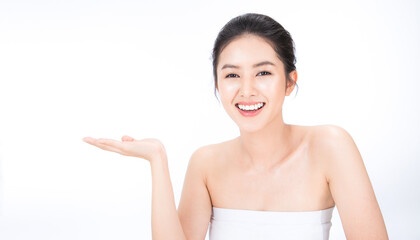 Beauty asian woman fair perfect healthy glow skin.Girl show empty copy space on open hand palm for text. Proposing a product. Gestures for advertisement. Asia girl pretty smile on face.