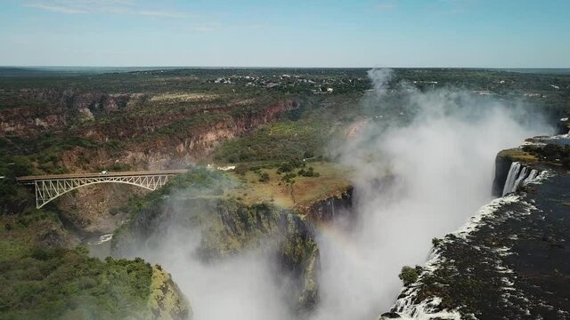 The Victoria Falls at the Border of Zimbabwe and Zambia in Africa. The Great Victoria Falls One of the Most Beautiful Wonders of the World. Unesco World Heritage. Aerial Shot. Camera Moves Backward