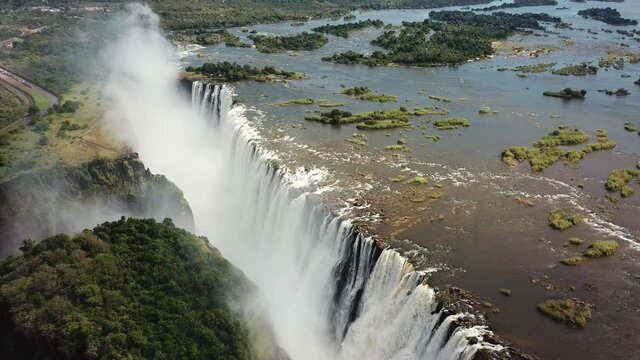 The Victoria Falls at the Border of Zimbabwe and Zambia in Africa. The Great Victoria Falls One of the Most Beautiful Wonders of the World. uUnesco World Heritage. Aerial Shot. Camera Moves Down