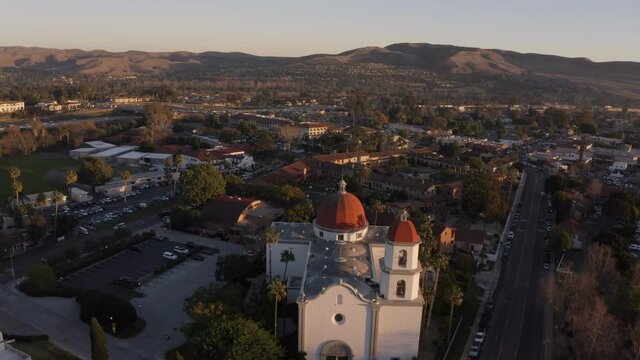 Sunset aerial view of the Spanish Colonial era mission and surrounding city of downtown San Juan Capistrano, California, USA. 