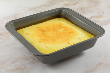 Baked lemon bar snack dessert in baking pan fresh out of the oven 