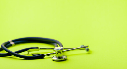 Selective focus of blue stethoscope on green background. For check heart or health check up concept. Copy space..