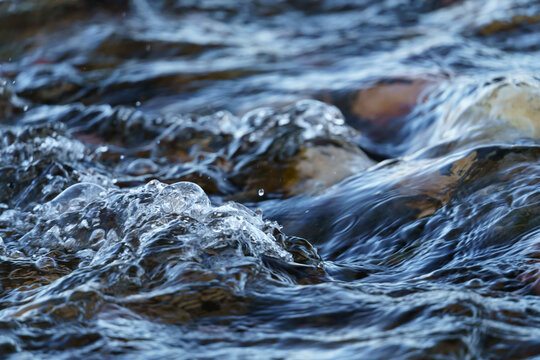 Closeup of Gurgling Water over Cobblestone in a River